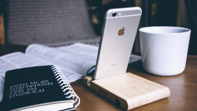 Iphone in a wooden phone holder